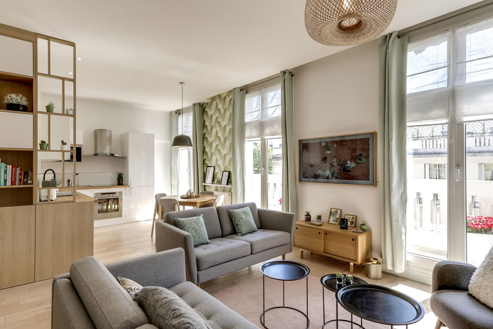 Mittelgroßes, Repräsentatives, Offenes Nordisches Wohnzimmer ohne Kamin mit weißer Wandfarbe, hellem Holzboden und TV-Wand in Paris