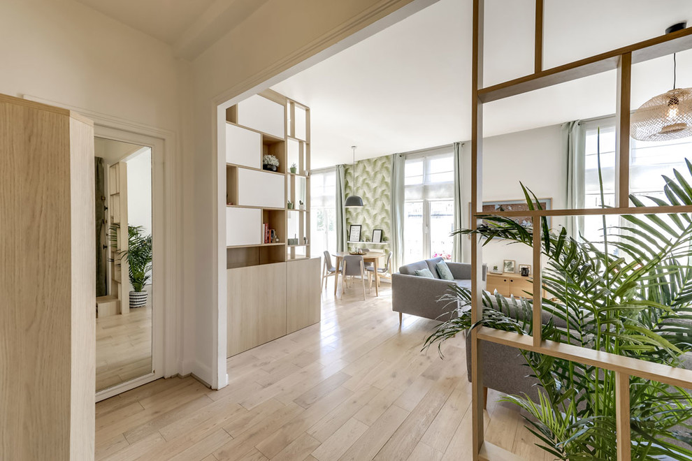 Photo of a medium sized scandi formal open plan living room in Paris with white walls, light hardwood flooring, no fireplace and a wall mounted tv.