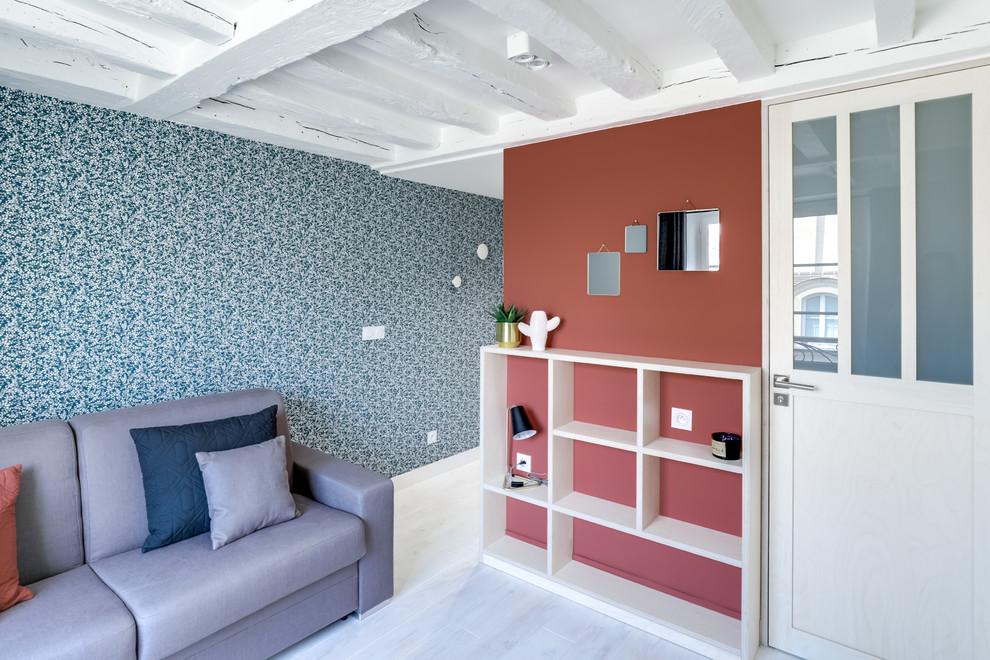 Kleines Nordisches Wohnzimmer ohne Kamin mit blauer Wandfarbe, gebeiztem Holzboden, TV-Wand und weißem Boden in Paris