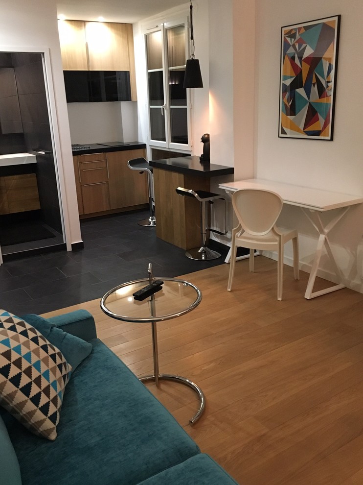 Kleines, Offenes, Fernseherloses Modernes Wohnzimmer ohne Kamin mit weißer Wandfarbe und braunem Holzboden in Paris
