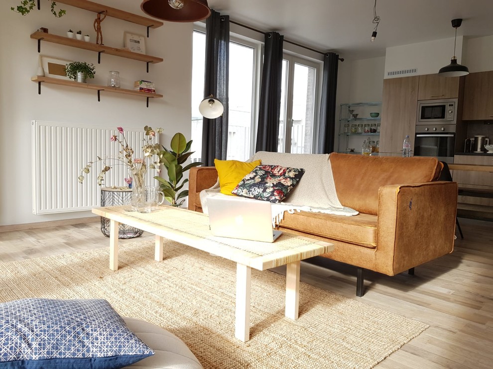 Inspiration for a mid-sized industrial enclosed light wood floor living room remodel in Brussels with white walls and no fireplace