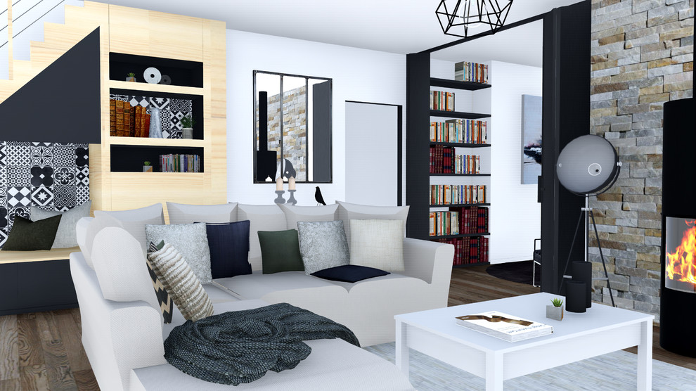 Esempio di un soggiorno industriale di medie dimensioni con libreria, pareti beige, pavimento in legno massello medio, stufa a legna e pavimento marrone