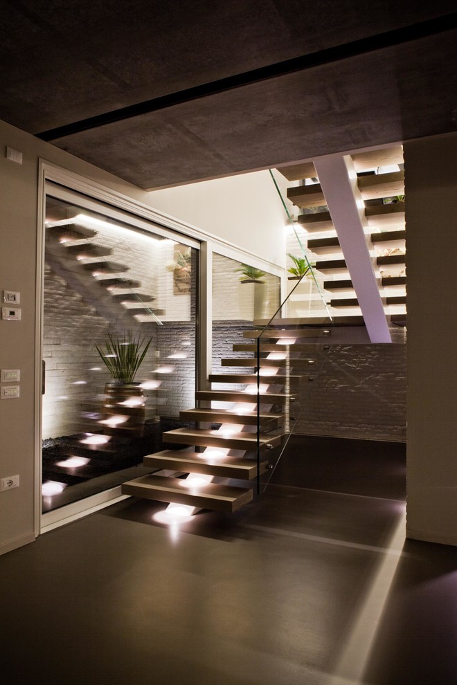 This is an example of a contemporary staircase in Venice with feature lighting.