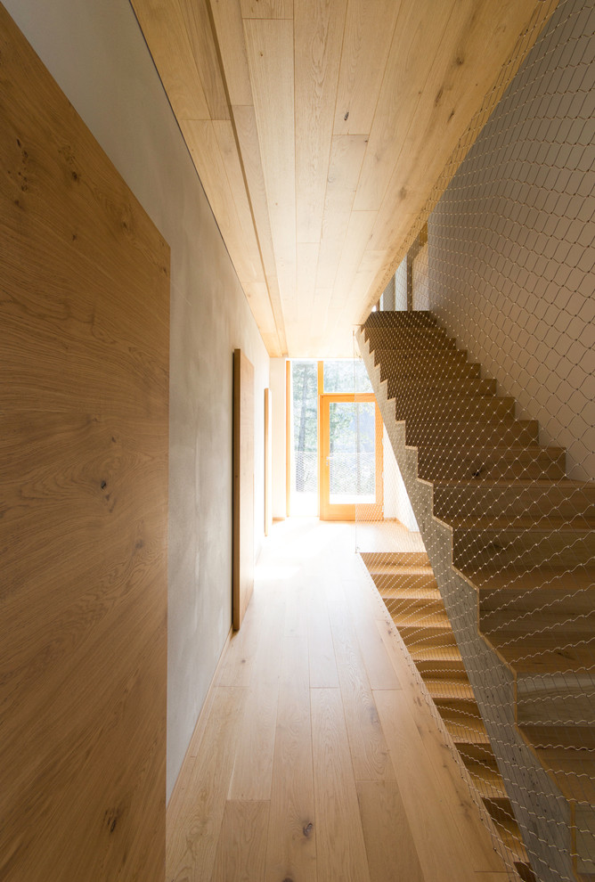 Example of a mid-sized danish wooden straight staircase design in Milan with wooden risers