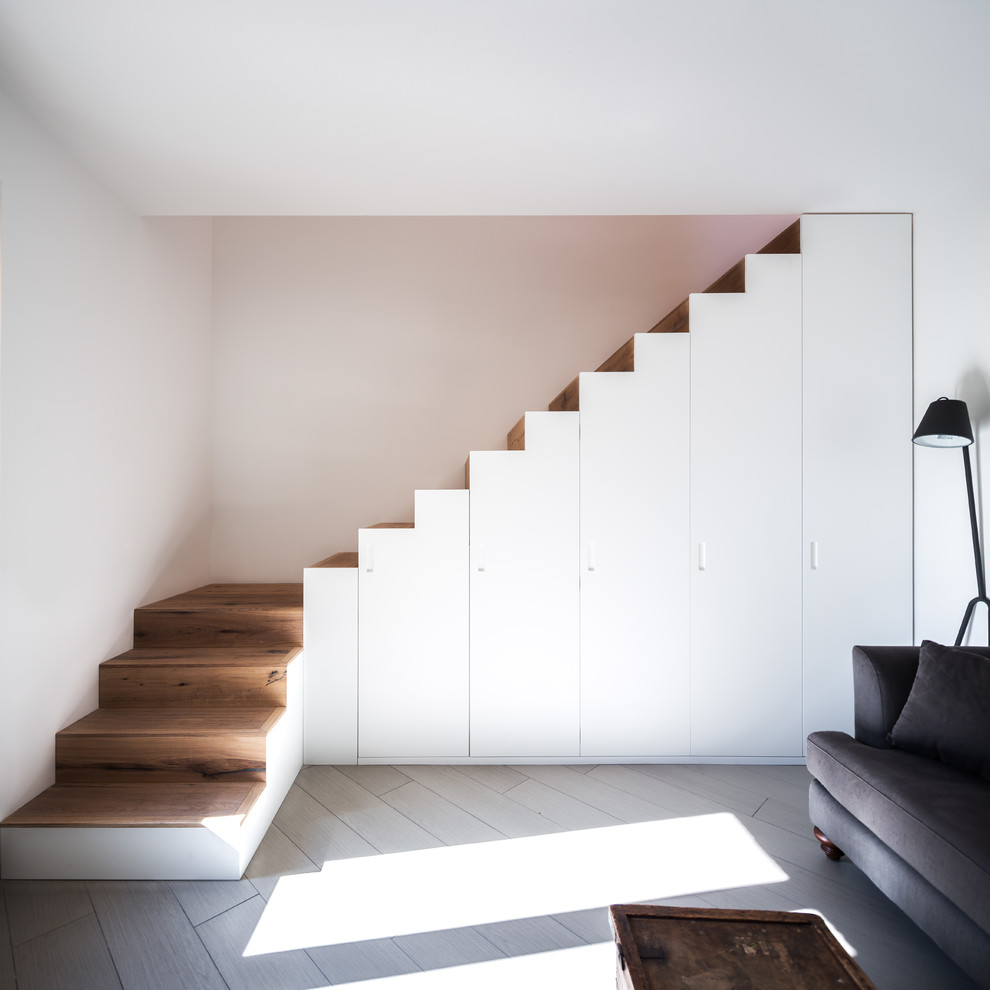 Mid-sized trendy wooden l-shaped staircase photo in Other with wooden risers