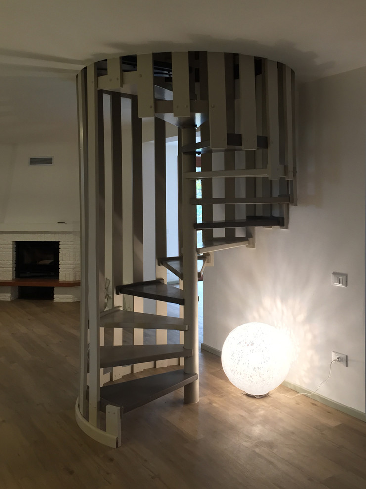 Large contemporary acrylic spiral mixed railing staircase in Other with open risers and feature lighting.