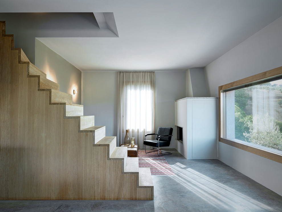 This is an example of a medium sized contemporary wood straight staircase in Milan with wood risers.