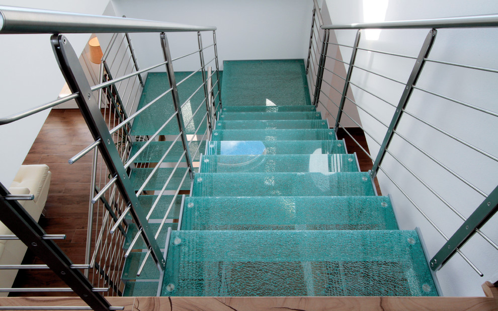 Стильный дизайн: огромная п-образная лестница в современном стиле с стеклянными ступенями без подступенок - последний тренд