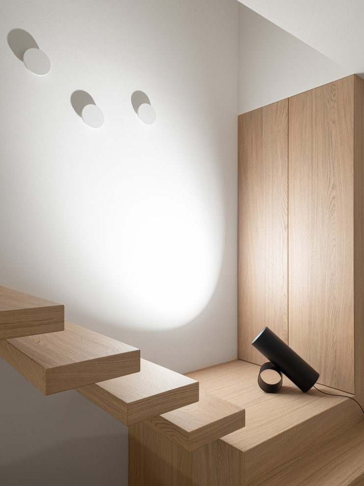 Inspiration for a contemporary wood staircase in Venice with open risers.