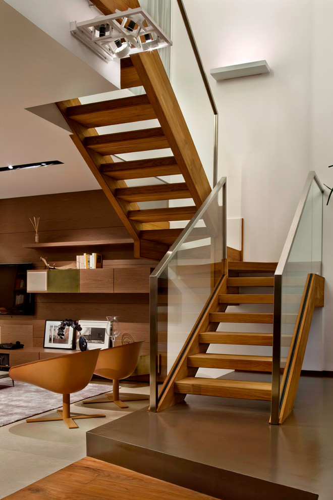 Inspiration for a modern wood u-shaped staircase in Milan with open risers.