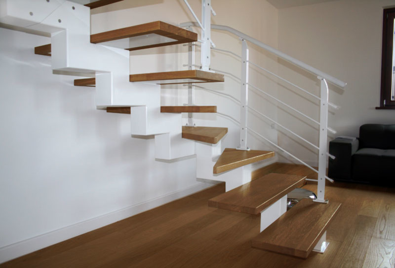 Photo of a large contemporary wood u-shaped staircase in Other with open risers.