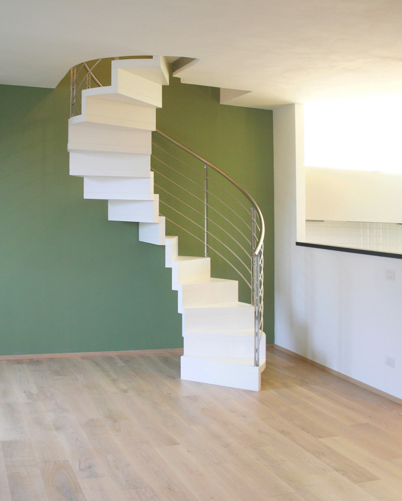 Design ideas for a medium sized contemporary wood spiral staircase in Bologna with wood risers.