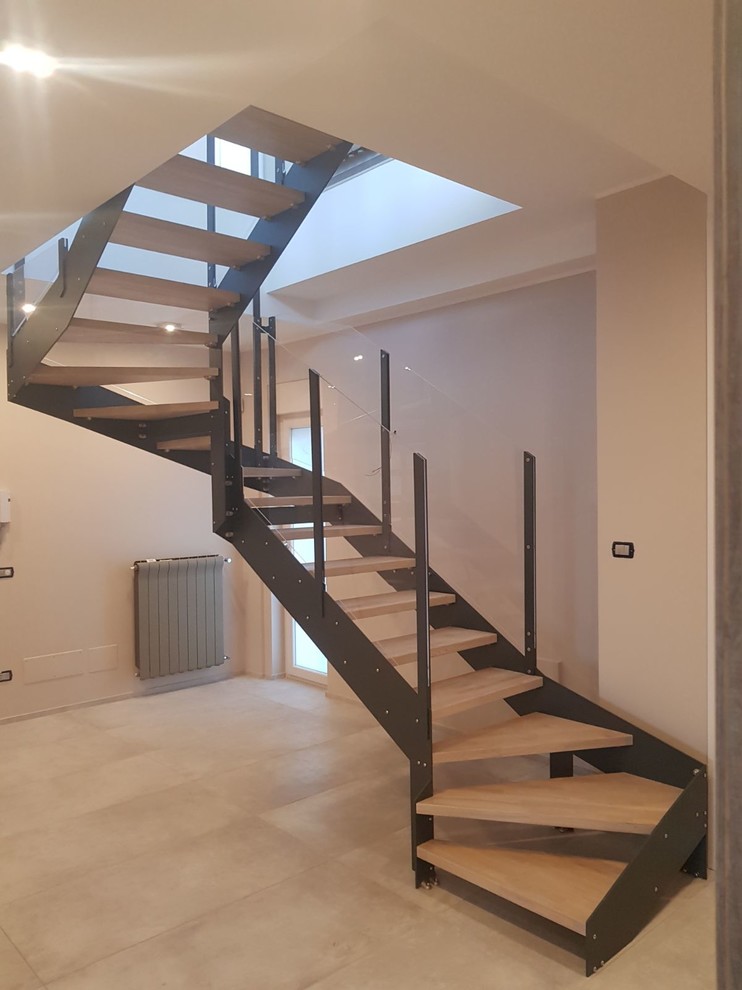This is an example of a large modern wood u-shaped mixed railing staircase in Catania-Palermo with open risers.