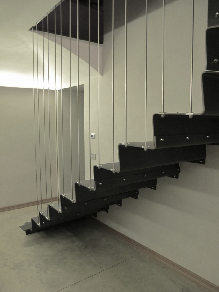 Inspiration for a small contemporary metal l-shaped staircase in Turin with metal risers.
