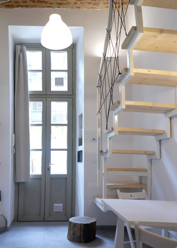 Пример оригинального дизайна: маленькая изогнутая лестница в стиле модернизм с деревянными ступенями и металлическими перилами без подступенок для на участке и в саду