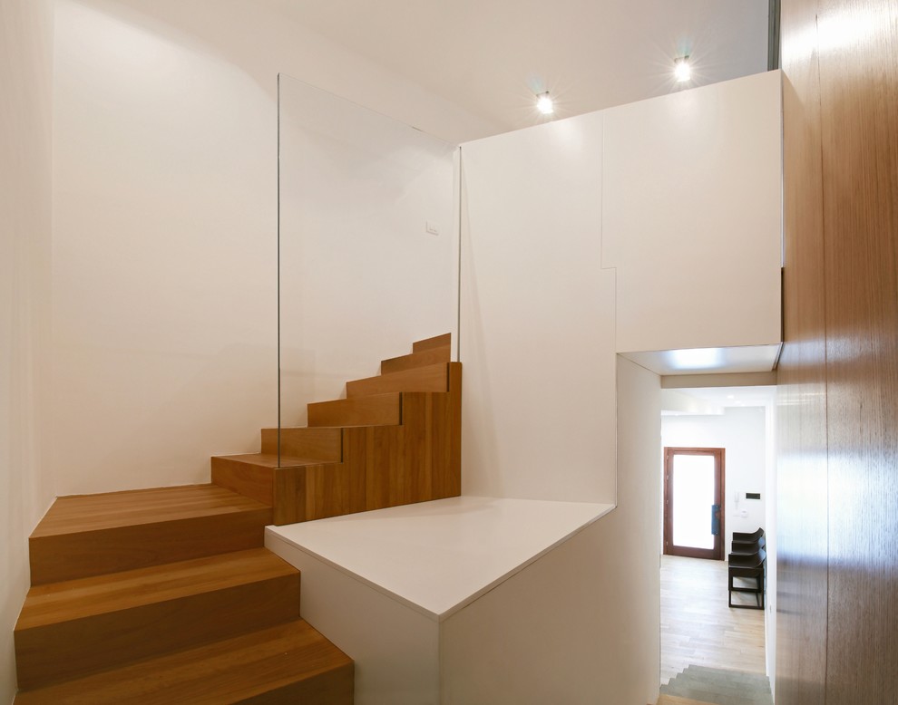 Ejemplo de escalera en U contemporánea de tamaño medio con escalones de madera y contrahuellas de madera