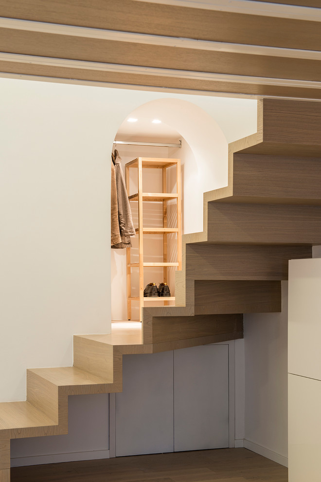 Inspiration for a small contemporary wood l-shaped glass railing staircase in Rome with wood risers.