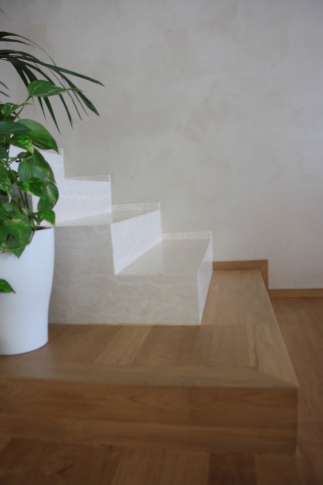 This is an example of a medium sized modern straight staircase in Other with marble treads and marble risers.