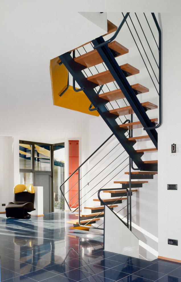 Large contemporary wood l-shaped staircase in Milan with open risers.