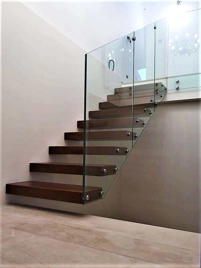 Small painted wood floating glass railing staircase in Catania-Palermo with open risers.