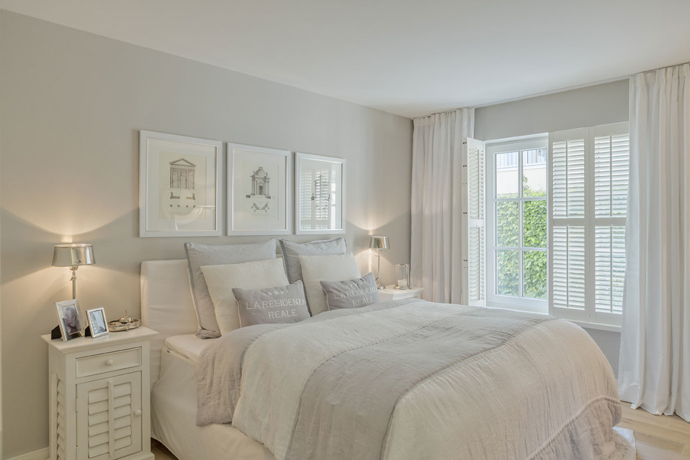Bedroom - mid-sized scandinavian master light wood floor bedroom idea in Munich with gray walls and no fireplace