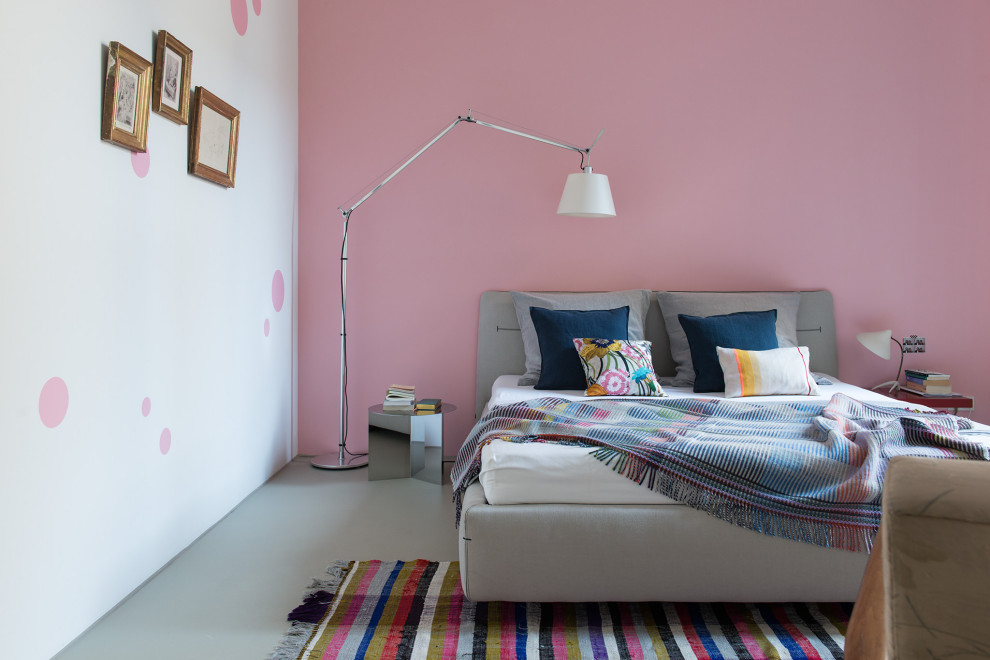 Example of a trendy gray floor bedroom design in Berlin with pink walls