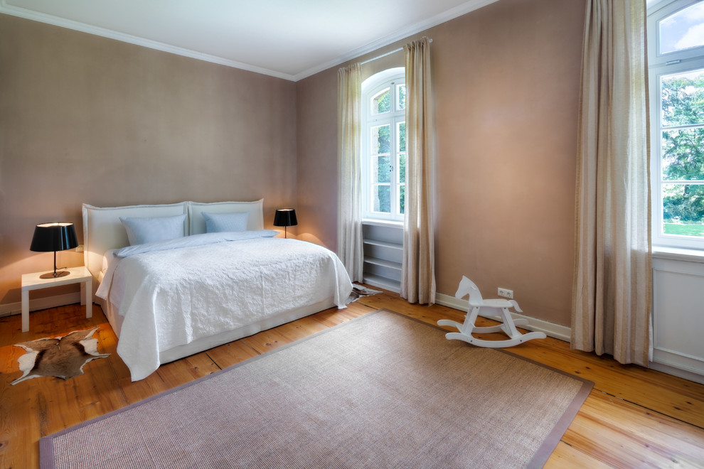 Diseño de dormitorio principal actual de tamaño medio sin chimenea con paredes marrones, suelo de madera oscura y suelo marrón