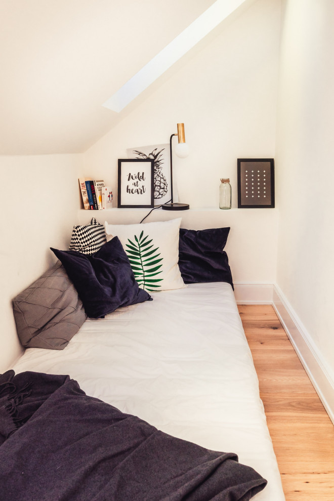 Kleines Modernes Gästezimmer ohne Kamin mit weißer Wandfarbe, hellem Holzboden und braunem Boden in Hamburg