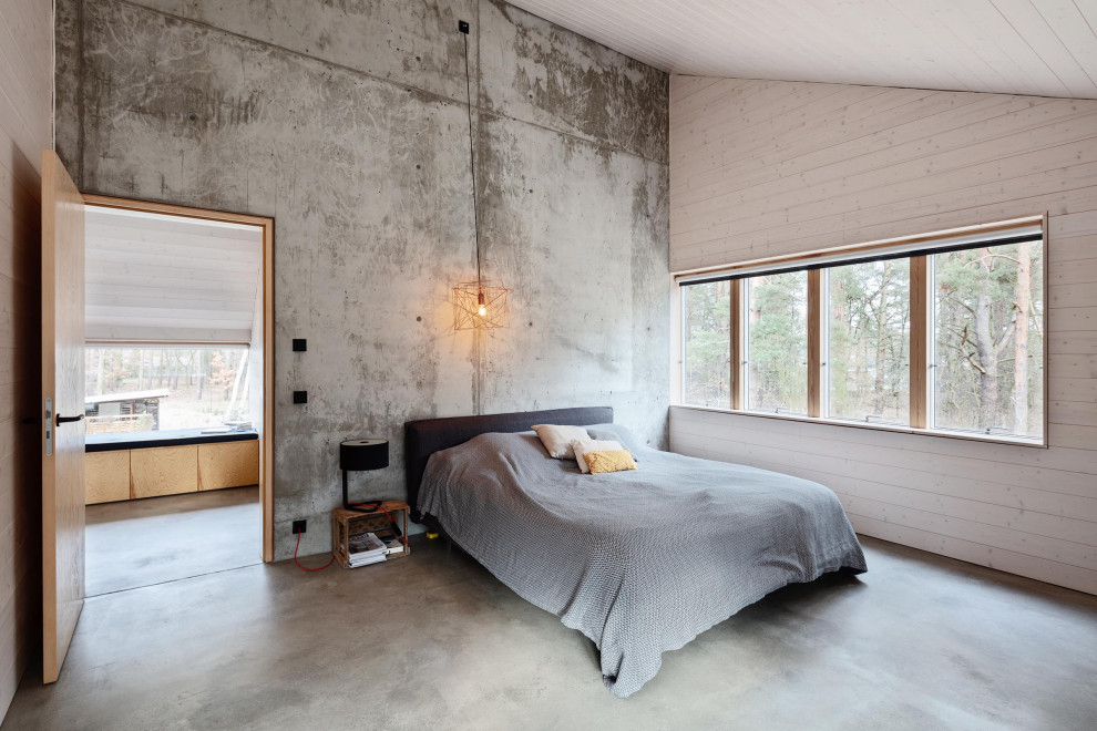 Contemporary master bedroom in Berlin with white walls, concrete flooring and grey floors.