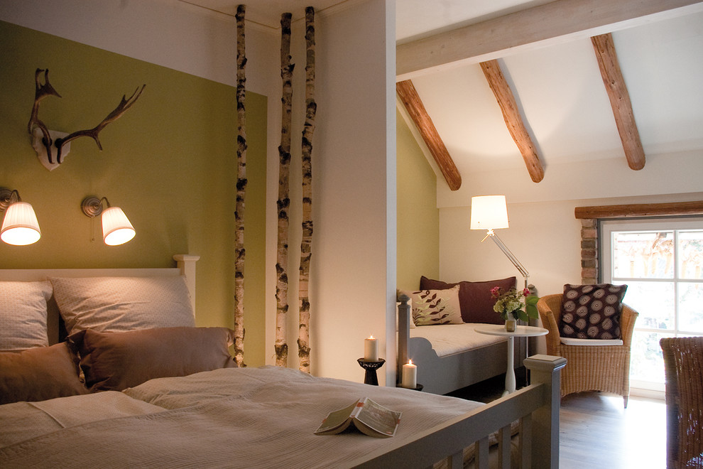 This is an example of a medium sized rural guest bedroom in Berlin with green walls, vinyl flooring and no fireplace.