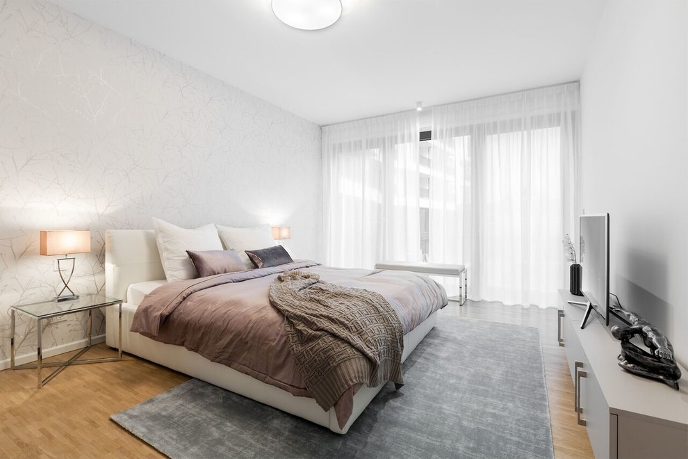 Inspiration for a medium sized contemporary master bedroom in Berlin with white walls, medium hardwood flooring and brown floors.