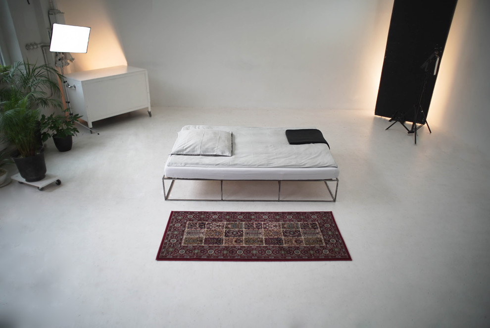 Esempio di una camera da letto minimalista con pareti bianche e pavimento bianco