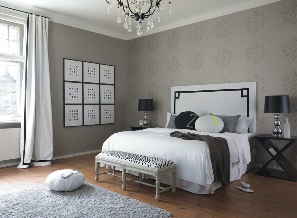 Design ideas for a medium sized eclectic master bedroom in Bremen with grey walls, medium hardwood flooring and no fireplace.