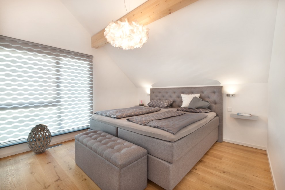 Großes Modernes Hauptschlafzimmer ohne Kamin mit weißer Wandfarbe, hellem Holzboden und braunem Boden in Stuttgart