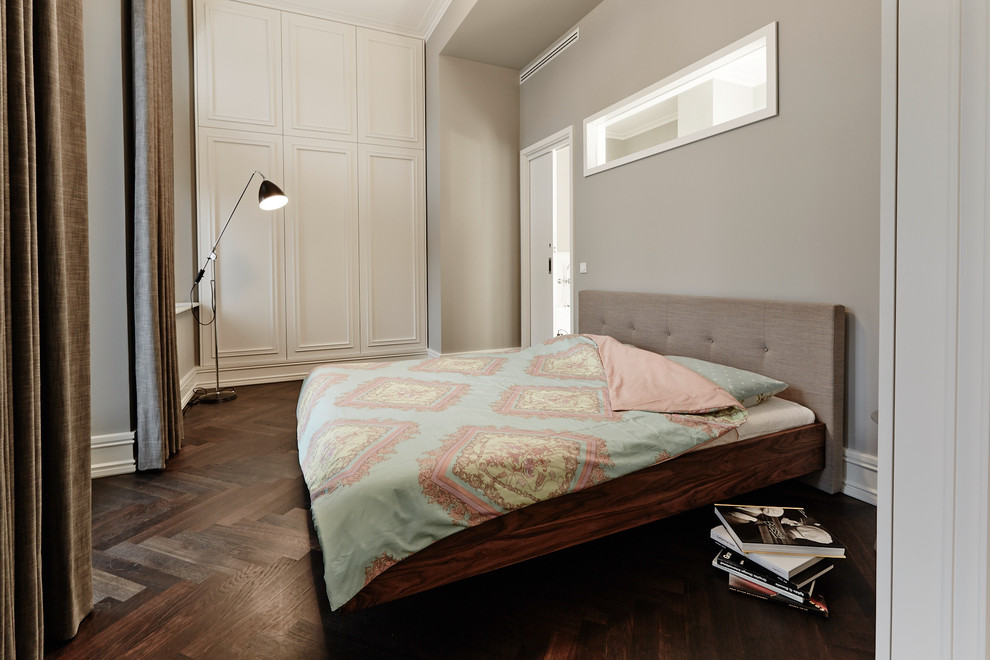 Medium sized traditional bedroom in Berlin with grey walls, no fireplace, medium hardwood flooring and brown floors.