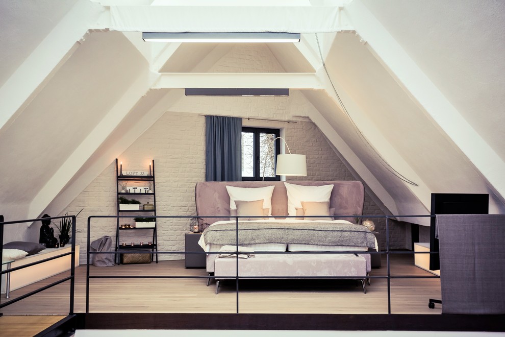 Design ideas for a medium sized contemporary mezzanine bedroom in Cologne with white walls and painted wood flooring.