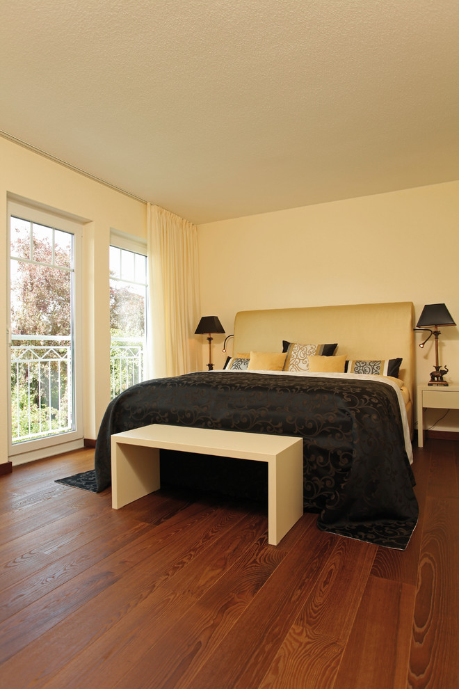 Modernes Hauptschlafzimmer ohne Kamin mit beiger Wandfarbe, dunklem Holzboden und braunem Boden in Sonstige
