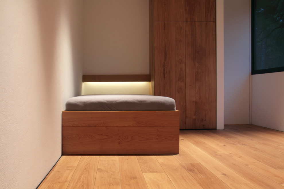 Geräumiges Gästezimmer ohne Kamin mit weißer Wandfarbe, hellem Holzboden und beigem Boden in Hannover