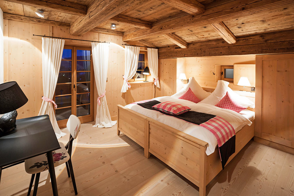 Bedroom - mid-sized country guest light wood floor and brown floor bedroom idea in Munich with brown walls