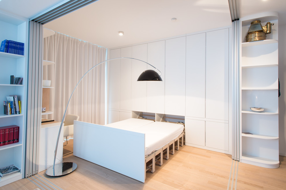 Inspiration för små moderna gästrum, med vita väggar och ljust trägolv