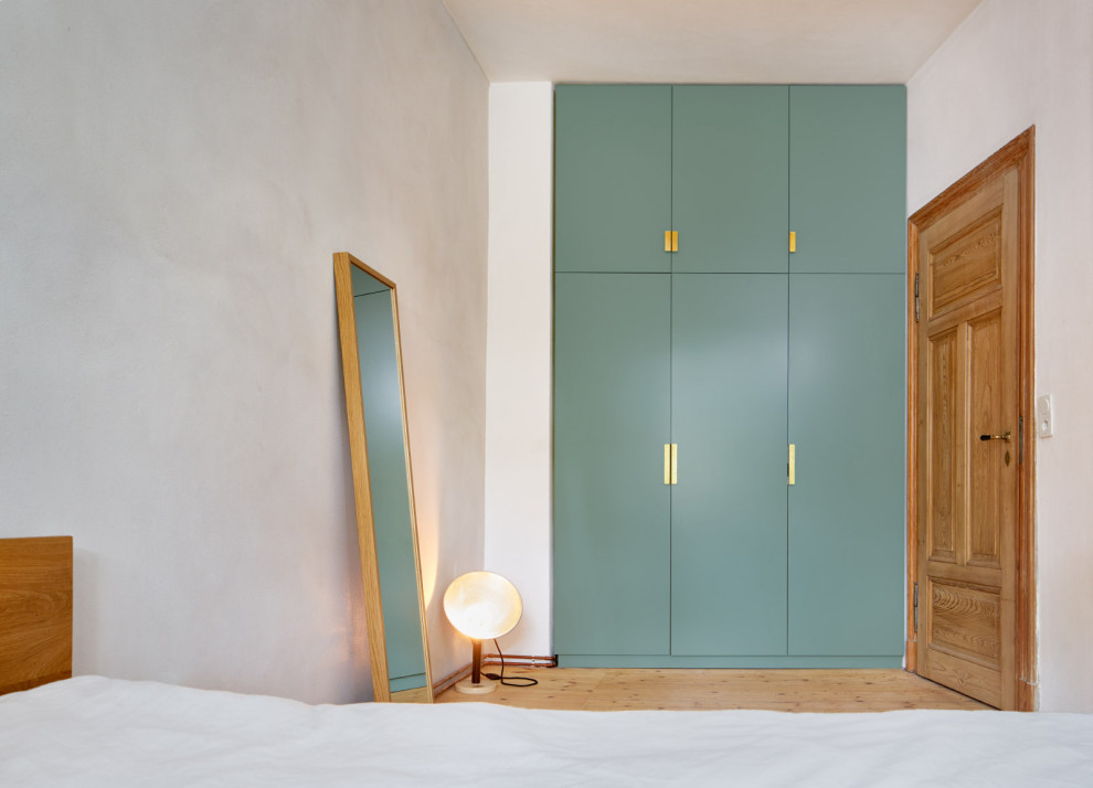 Mittelgroßes Modernes Hauptschlafzimmer ohne Kamin mit weißer Wandfarbe und hellem Holzboden in Leipzig