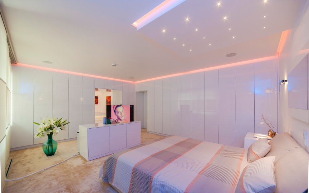 Geräumiges Modernes Hauptschlafzimmer mit weißer Wandfarbe, Teppichboden und beigem Boden in Köln