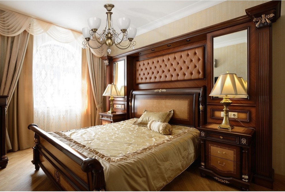 Diseño de dormitorio principal tradicional de tamaño medio con paredes beige, suelo de madera en tonos medios y suelo marrón