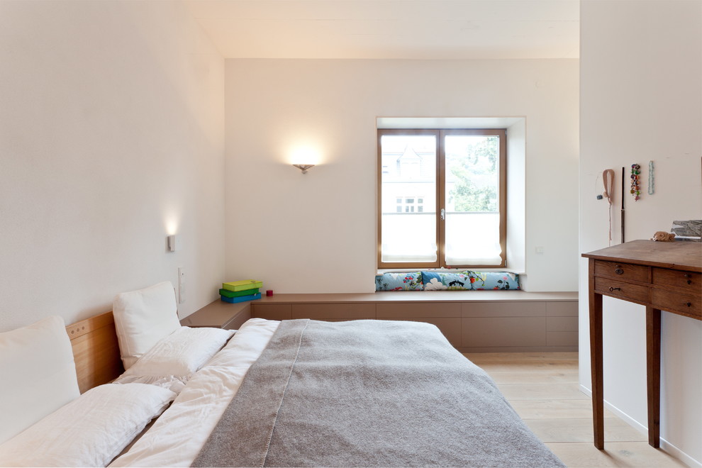 Mittelgroßes Modernes Hauptschlafzimmer ohne Kamin mit weißer Wandfarbe und hellem Holzboden in Sonstige