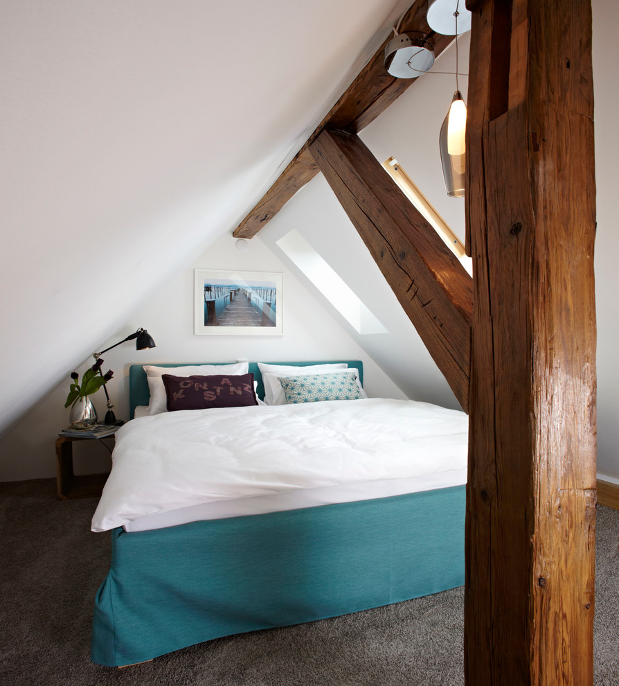 Kleines Modernes Schlafzimmer im Dachboden ohne Kamin mit weißer Wandfarbe und Teppichboden in München