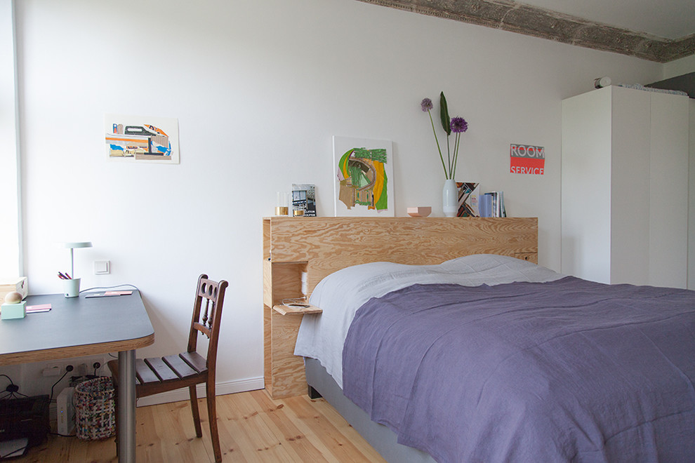 Medium sized eclectic master bedroom in Berlin with white walls, light hardwood flooring and brown floors.