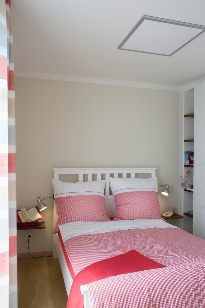 На фото: спальня среднего размера в современном стиле с бежевыми стенами и паркетным полом среднего тона