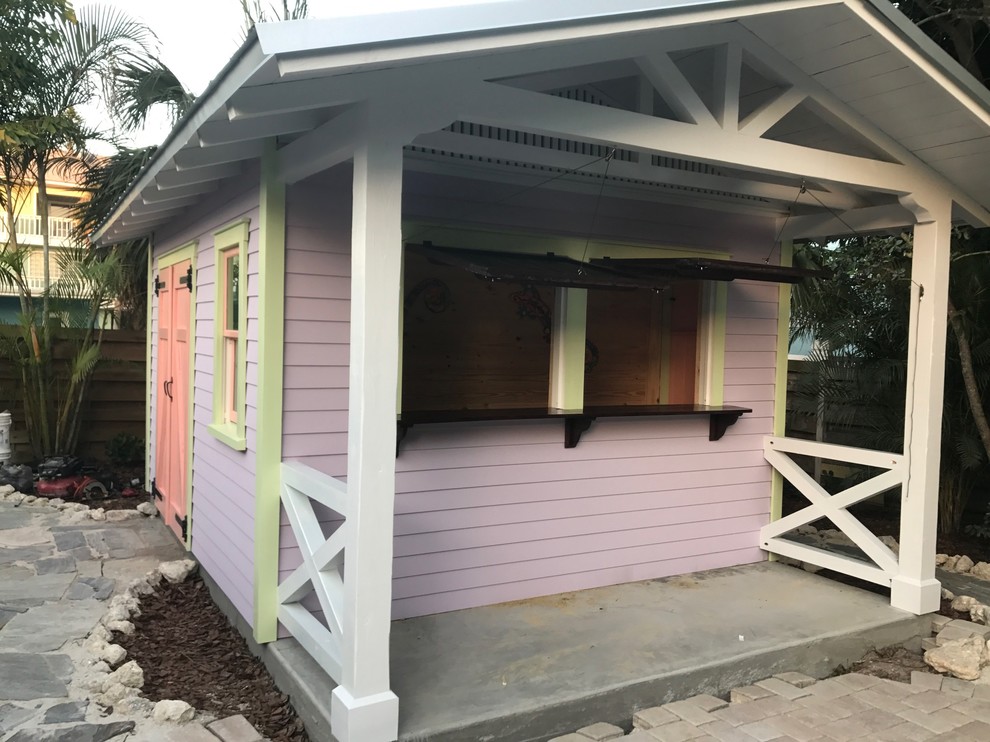 This is an example of a small world-inspired detached garden shed and building in Tampa.