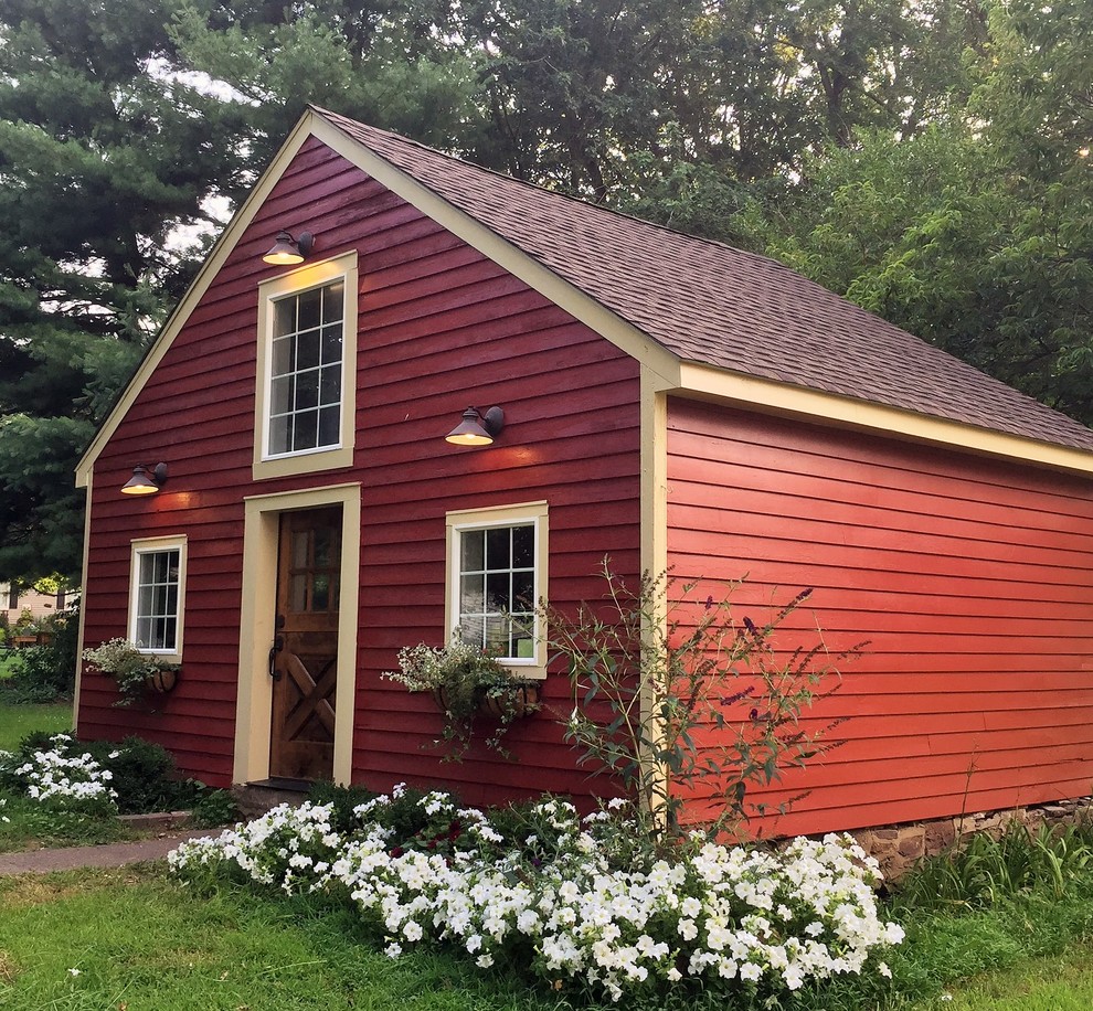 Example of a mid-sized farmhouse detached guesthouse design in Philadelphia