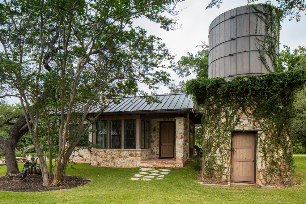 Example of a country detached guesthouse design in Austin